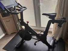 Peloton Bike With Weights And Protective Floor Mat