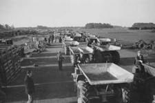 Dump trucks & rubble shifters line up giant runway during const- 1942 Old Photo