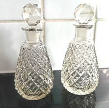 2 perfect hobnail cut glass perfume bottles with faceted stoppers.