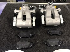 2 REAR BRAKE CALIPERS +