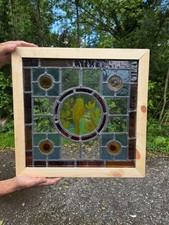 1910 Antique leaded glass window with bird on a branch and amber bullseyes...