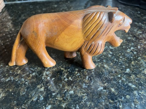 Small wooden hand carved lion - hand,