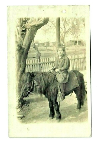 Rppc young girl riding - rppc,