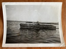 Man Driving Wooden Speedboat