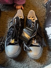 miley cyrus converse silver glitter base and with a velour type top 2 