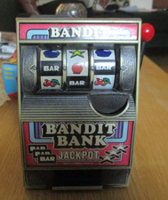 Vintage Radica Bandit Bank One Arm Mechanical Slot Machine Coin Bank GWO.