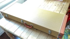 Tweed  finish guitar hard guitar case with plush red inside.