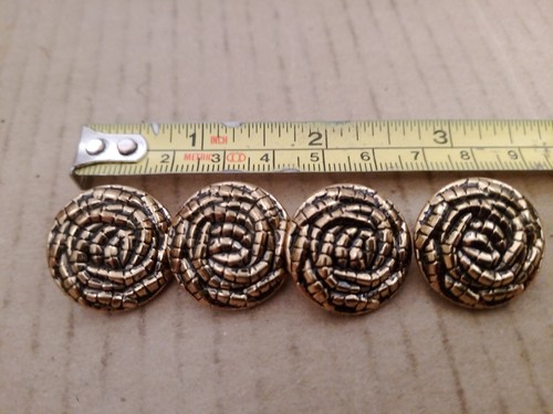 Four gold colored buttons - four,