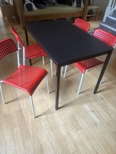 Ikea  Black/brown Table And Four Red Chairs.