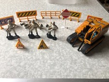 construction roadway, workmen and signs with a caterpiller. not britains.