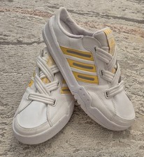 white and yellow adidas Forum
