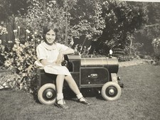 VINTAGE SNAPSHOT PHOTO GIRL ON RIDE ON PEDAL TRAIN TOY IN GARDEN