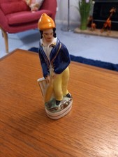 A Staffordshire Cricket Figure.