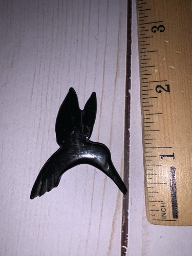 Hand carved hummingbird from - hand,