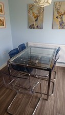 IKEA glass table Gilvarp, with 6 ( 4 blue, 2 white ) IKEA Tobias chairs.