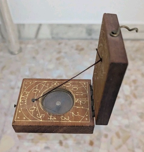 Antique sundial and - and, compass