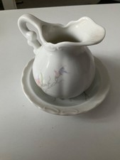 Small  jug and bowl wash set. Good condition. 10cm tall when standing on bowl.