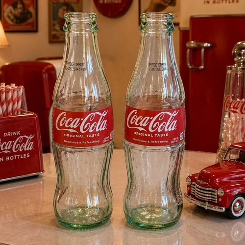 Two empty coca cola - empty, glass