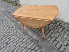 Ercol round drop leaf dining table. Blue label 1960s/70s