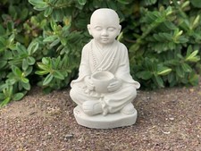 Concrete young Buddha with a
