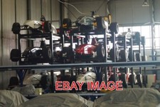 PHOTO  REDUNDANT SINGLE-SEATER RACE CARS  OBSERVED THROUGH AN OPEN DOORWAY TO A