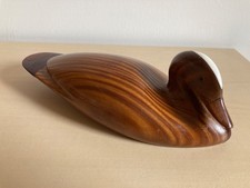 A lovely carved wooden sitting duck with a cream streak on forehead,  9" long