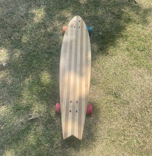 Two bare feet - wooden, longboard