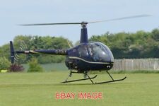 PHOTO  HELICOPTER ROBINSON R22 BETA 'G-TOLY' C/N 2809. BUILT 1998. SEEN LANDING