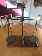 Old vintage balance scales brass on wood plinth