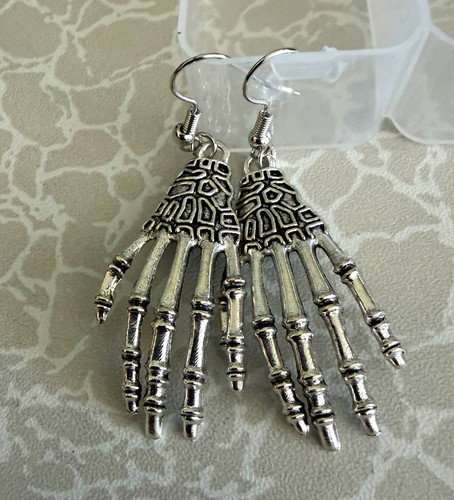 Silver tone skeleton hand - tone,