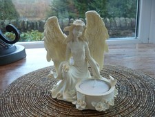 Angel in contemplation t-light holder. Lovely detailing. 11cm tall.
