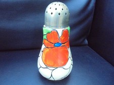 A Clarice Cliff sugar sifter in SCARLET FLOWER  pattern.