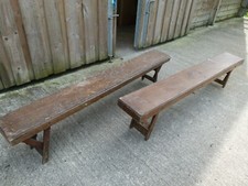 1970's USEFUL PAIR OF GYM STYLE FOLDING STAINED PINE BENCHES IN GOOD CONDITION.