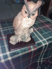 large lovely owl statue displayed on a wooden plinth