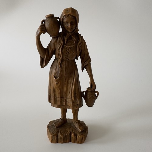 Figurine female carrying - of,