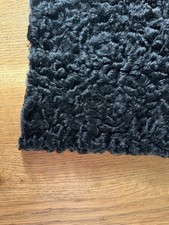Genuine length of black astrakhan fur
