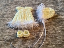 Hand knitted dolls clothes to
