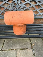 A reclaimed terracotta hooded chimney cowl.