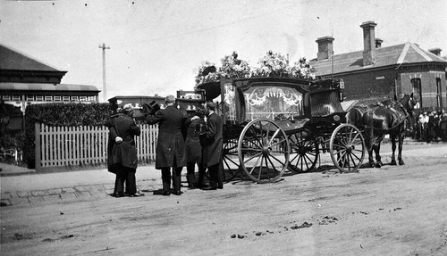 Coffin being placed - placed, in
