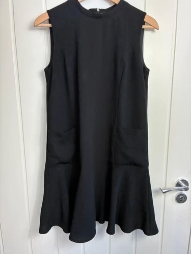 Reserved black high - neck, frill