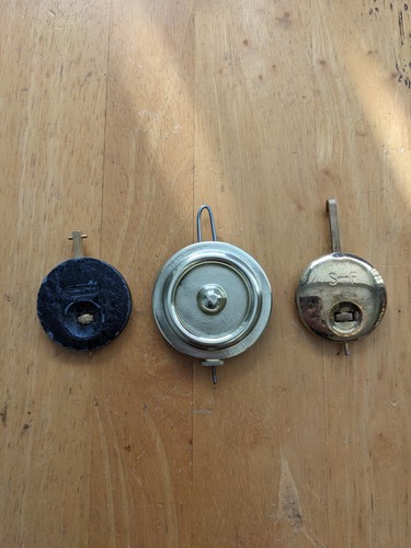 Three small clock pendulums - three,