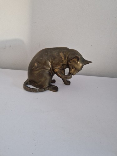Realistic brass cat licking - brass,