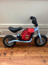 child's blue Puky balance bike