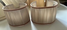A pair of cream silk pleated