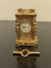 Bronze miniature carriage clock with heavily embossed design
