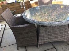 Round, glass rattan garden table and 4 chairs
