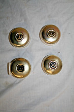 Four vintage brass and porcelain dolly switches, one with 5 amp socket.