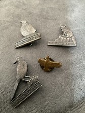 4 OLD HUNTING RELATED BADGES.
