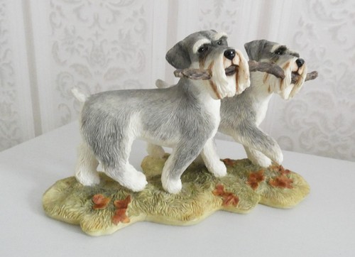 Schnauzer pair holding stick - holding,