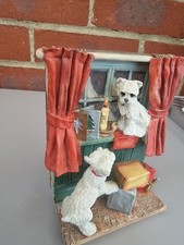 Two Westie,s Playing In A Window At Christmas